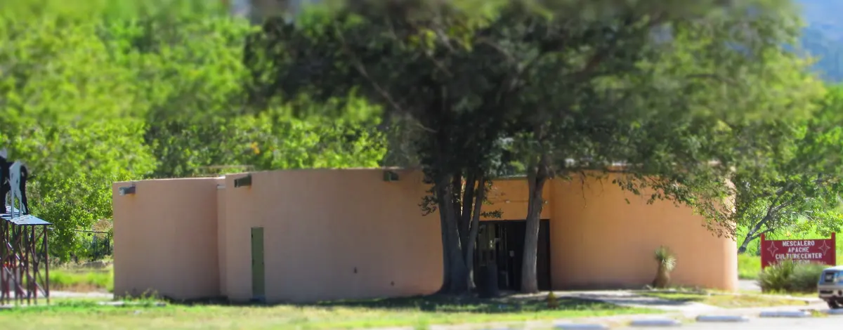 Mescalero Apache Cultural Center beneath mature trees