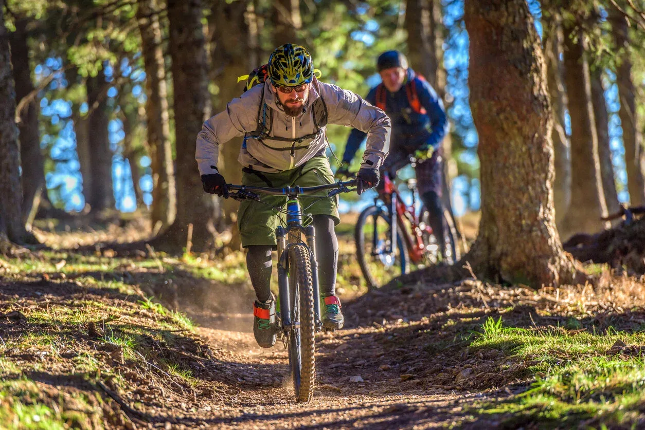 Mountain bikers riding wooded singletrack in Ruidoso