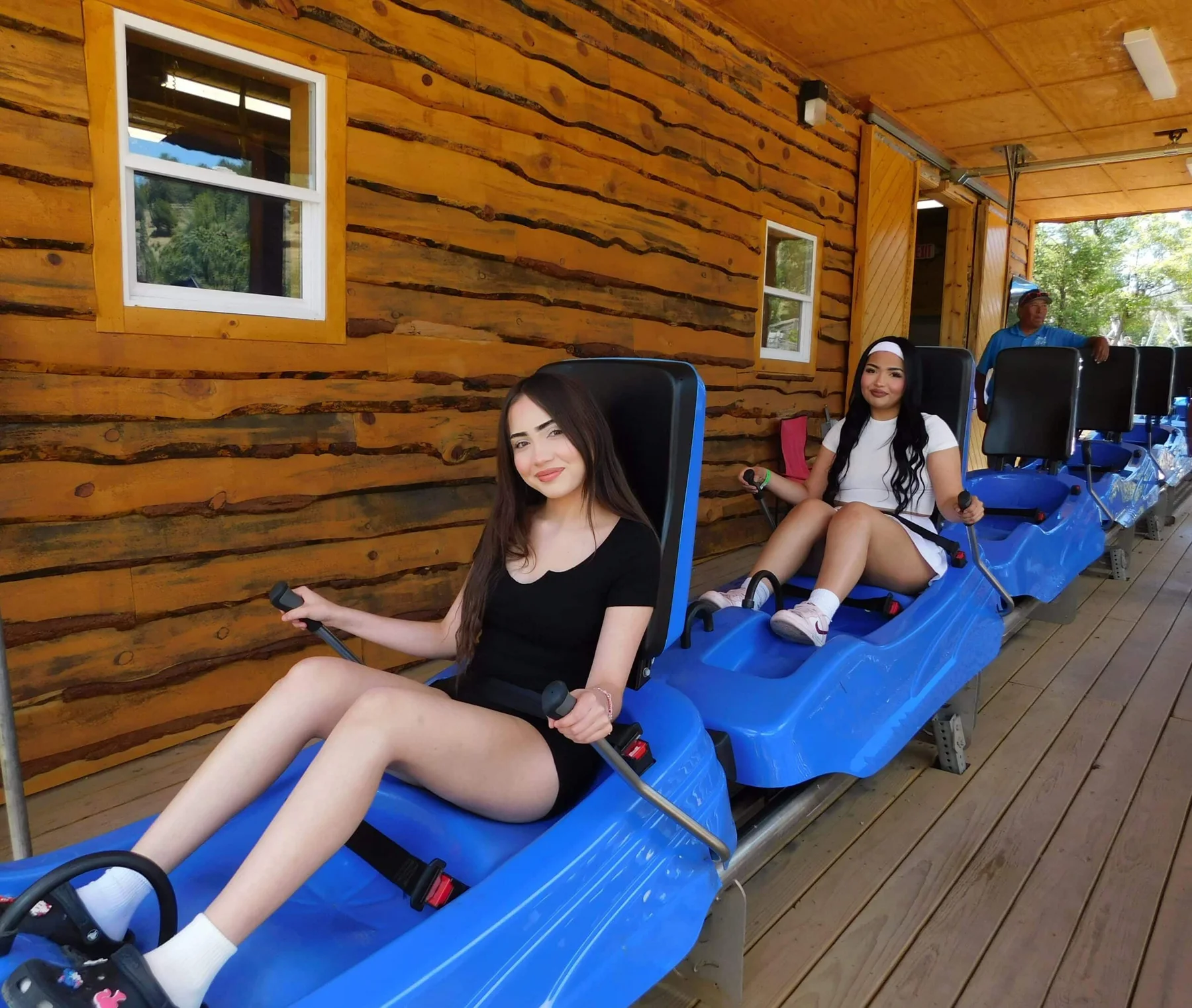 Riders seated in blue mountain coaster carts at Ruidoso Winter Park