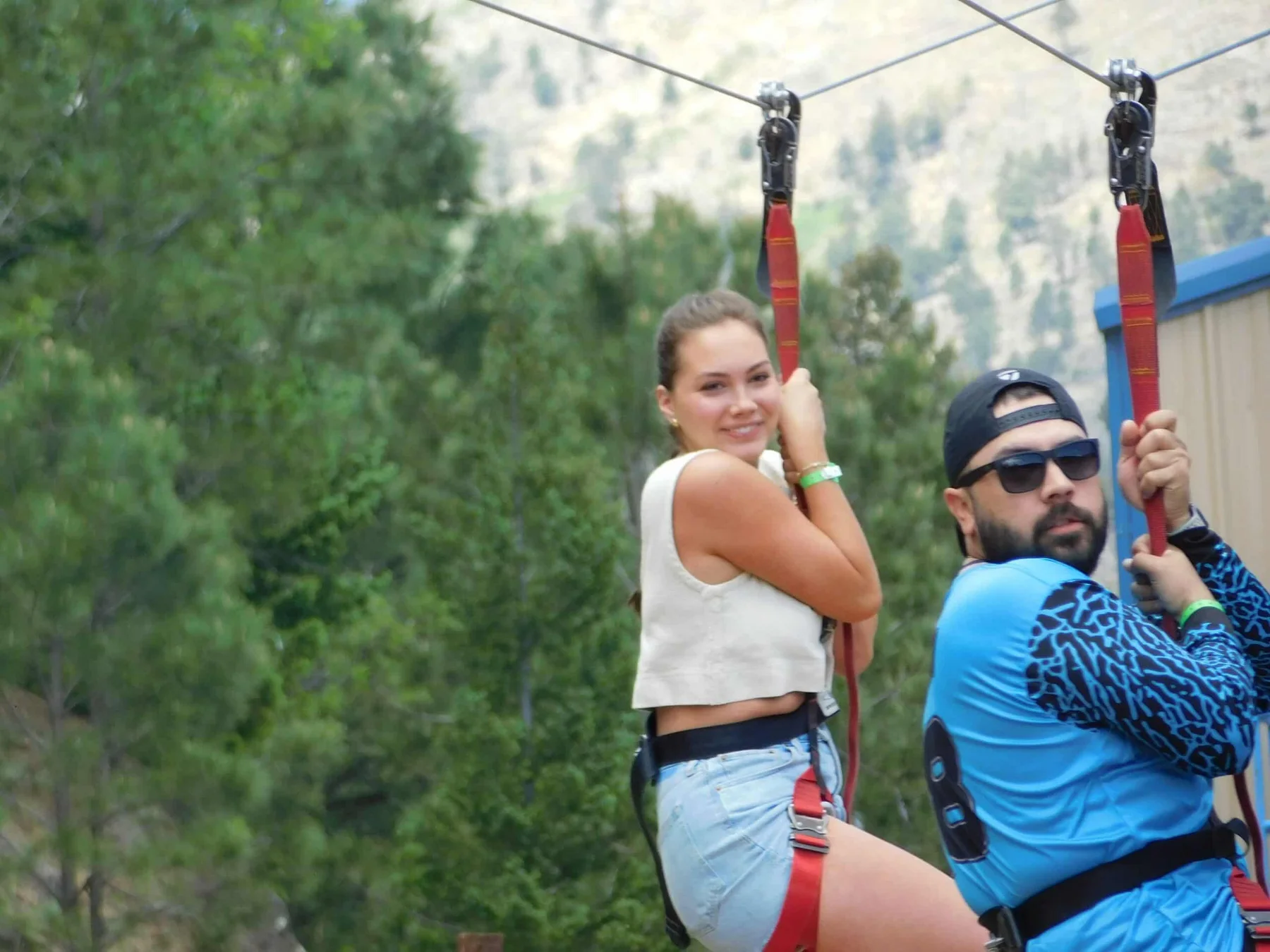 Two visitors on the family zipline at Ruidoso Winter Park
