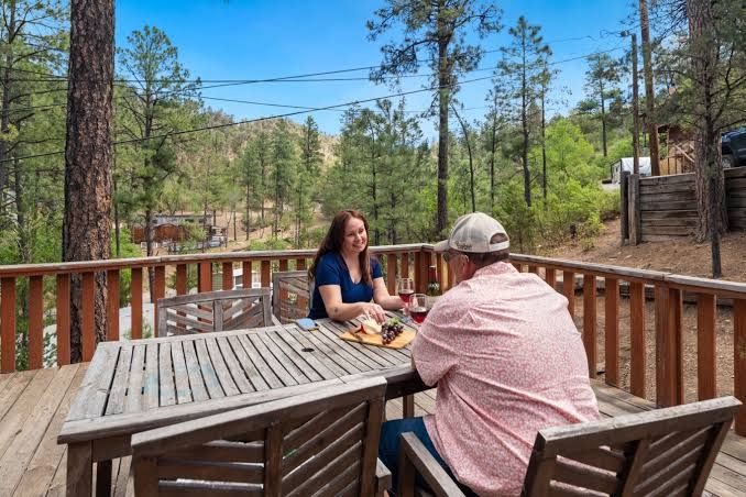 Two guests sharing a table on a sunny deck