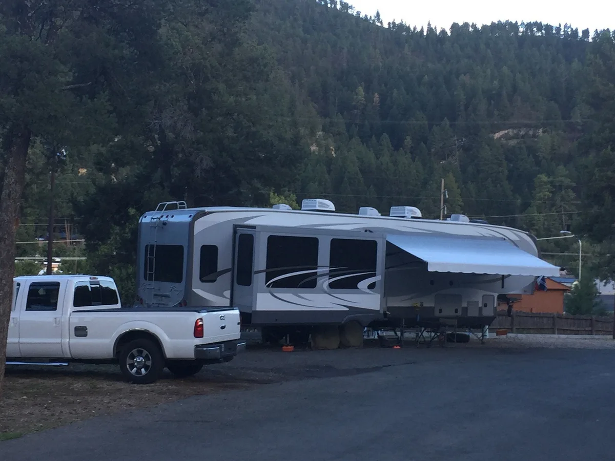 An RV settled at the park after sunset