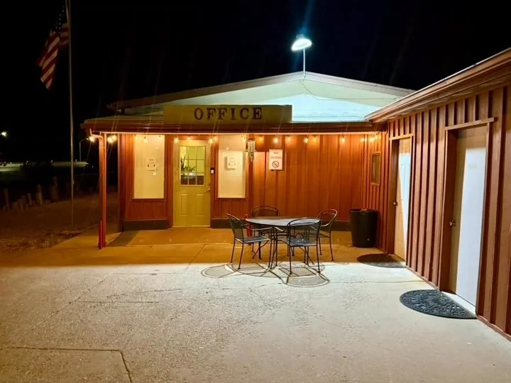 The same office porch lit at night
