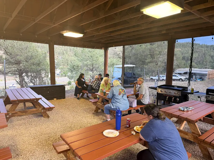 Guests sharing a meal at the pavilion picnic tables