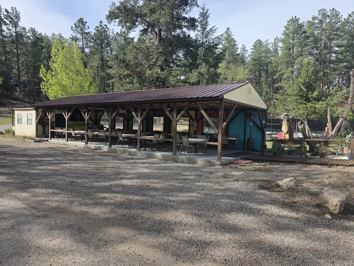 Open air pavilion beside a gravel gathering area