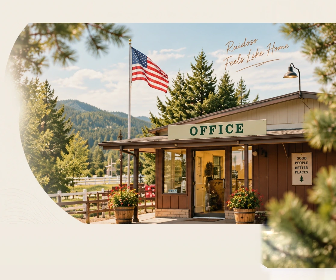 The park office with the American flag flying out front, framed by pines with the mountains behind. Hand lettering reads: Ruidoso feels like home.